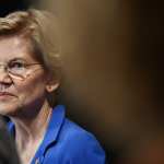 A close shot of Elizabeth Warren wearing a blue blouse.