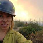 Eleonore Jordan Anderson takes a selfie in front of a landscape.