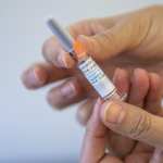 A person holding a flu vaccine.