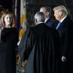 President Donald Trump watches as Supreme Court Justice Clarence Thomas administers the Constitutional Oath to Amy Coney Barrett on the South Lawn of the White House in Washington, Monday, Oct. 26, 2020, after Barrett was confirmed by the Senate earlier in the evening.