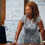 Latosha Brown standing behind a desk.