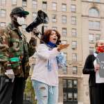 A woman speaking at a protest.