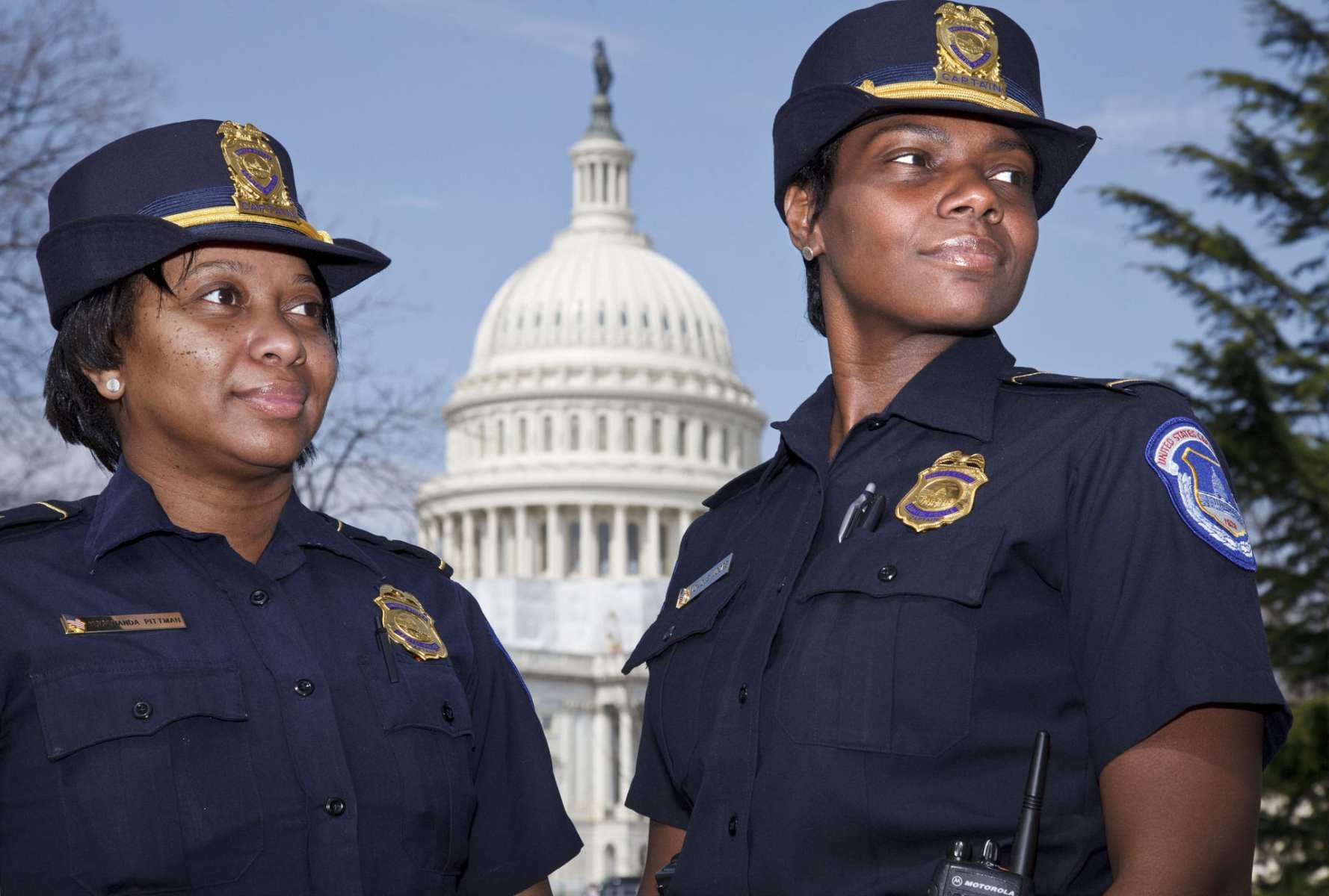 Officers Yogananda "Yogi" Pittman, left, and Monique Moore stand in front of the Capitol.
