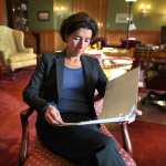 Gina Raimondo reads a document in her office.