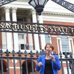 Attorney General Maura Healy standing in front of the Massachusetts State House.