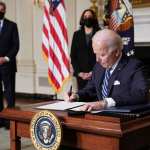 US Vice President Kamala Harris and Special Presidential Envoy for Climate John Kerry watch as US President Joe Biden signs executive orders.