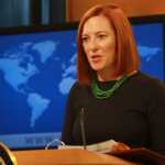 Jennifer Psaki speaks to journalists from a podium.