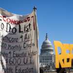 Signs at the Capitol in support of the relief bill