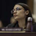 Rep. Alexandria Ocasio-Cortez sitting at a hearing.