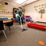 A teacher cleans her classroom.