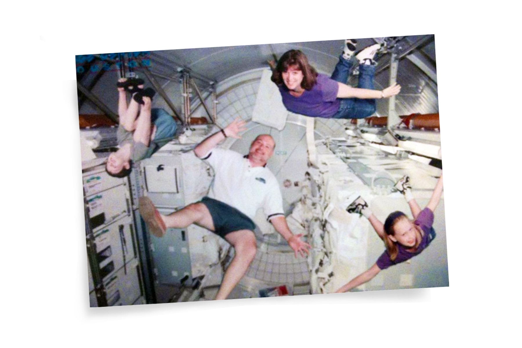 A photo of Hayley Arceneaux floating with her family in a space simulation.
