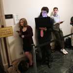 Congressional intern, Sydni Nadler, left, waits in line with others prior to a House Judiciary Committee Impeachment Inquiry hearing.