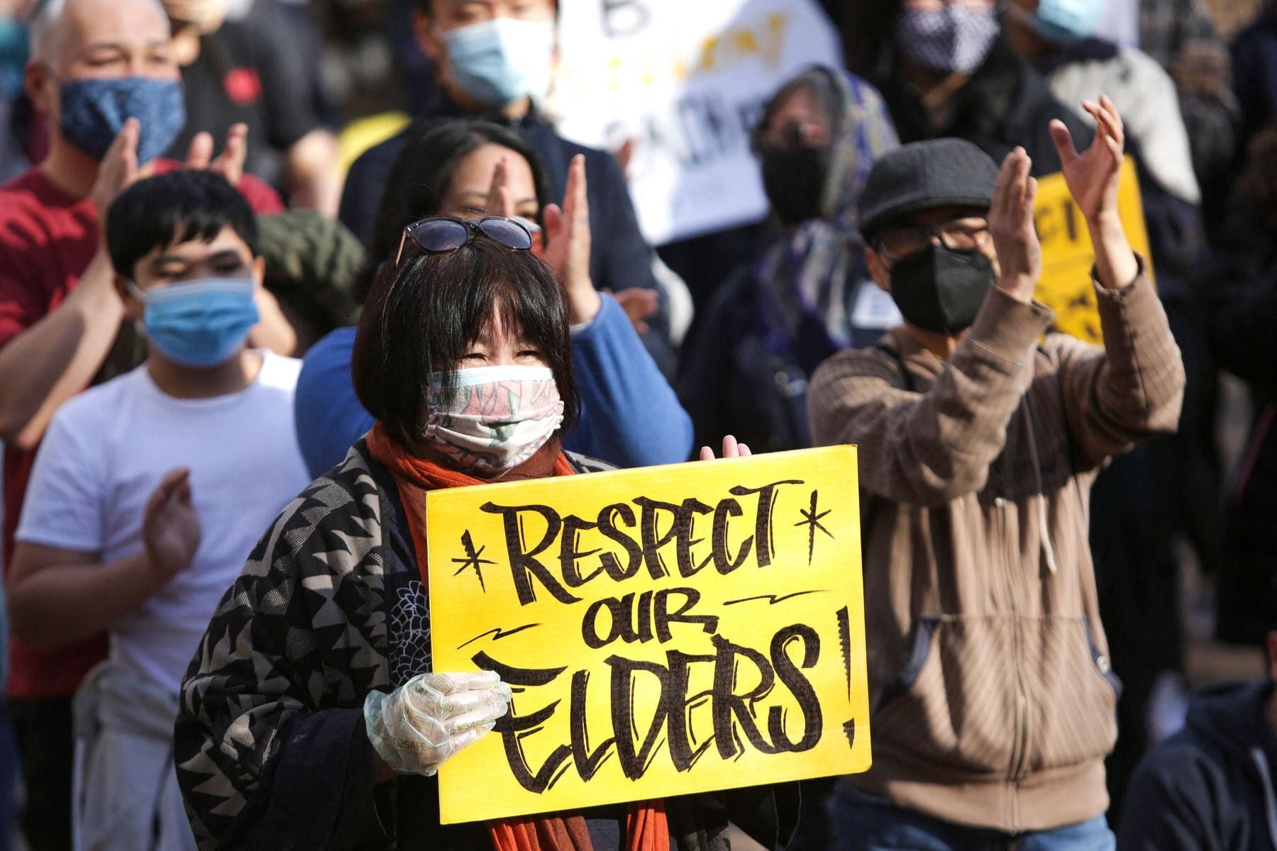 A woman holds a sign that reads 