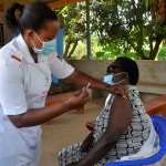 A medical worker administers the COVID-19 vaccine to a recipient at Kasangati Health Center, Wakiso District, Central Region, Uganda.