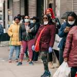 Pedestrians wear face masks on Fulton Street.