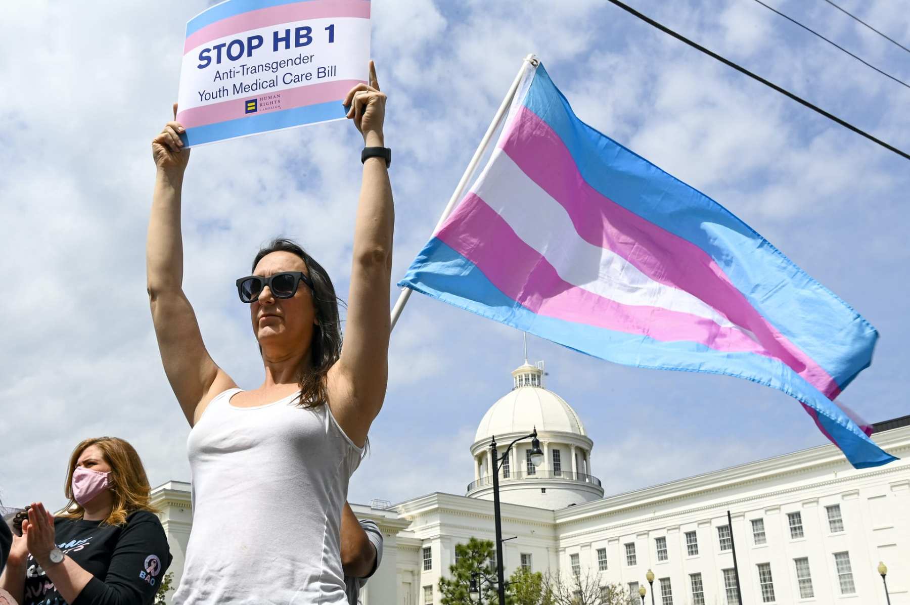 A woman holds a sign reading "Stop HB1" during a rally at the Alabama State House to draw attention to anti-transgender legislation introduced in Alabama on March 30, 2021 in Montgomery, Alabama. There are so far 192 anti-LGBTQ bills under consideration in state legislatures across the United States. Of those, 93 directly target transgender people.