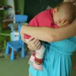 A woman holding a baby.