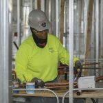 Woman works at a construction site.