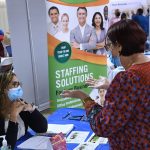 A woman seeking employment speaks to a recruiter at the 25th annual Central Florida Employment Council Job Fair at the Central Florida Fairgrounds. More than 80 companies were recruiting for over a thousand jobs.