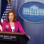 White House Press Secretary Jen Psaki stands at a podium.