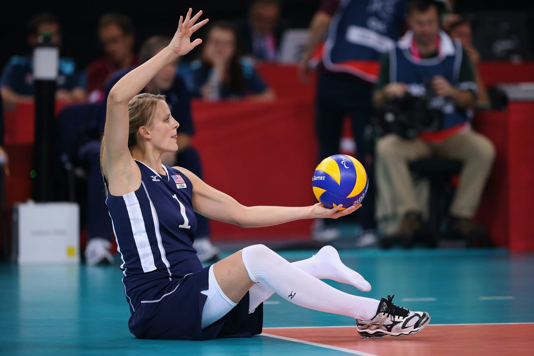 American volleyball player Lora Webster plays in a sitting volleyball game.