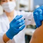 A doctor administers a vaccine to a patient.