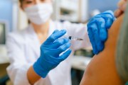 A doctor administers a vaccine to a patient.