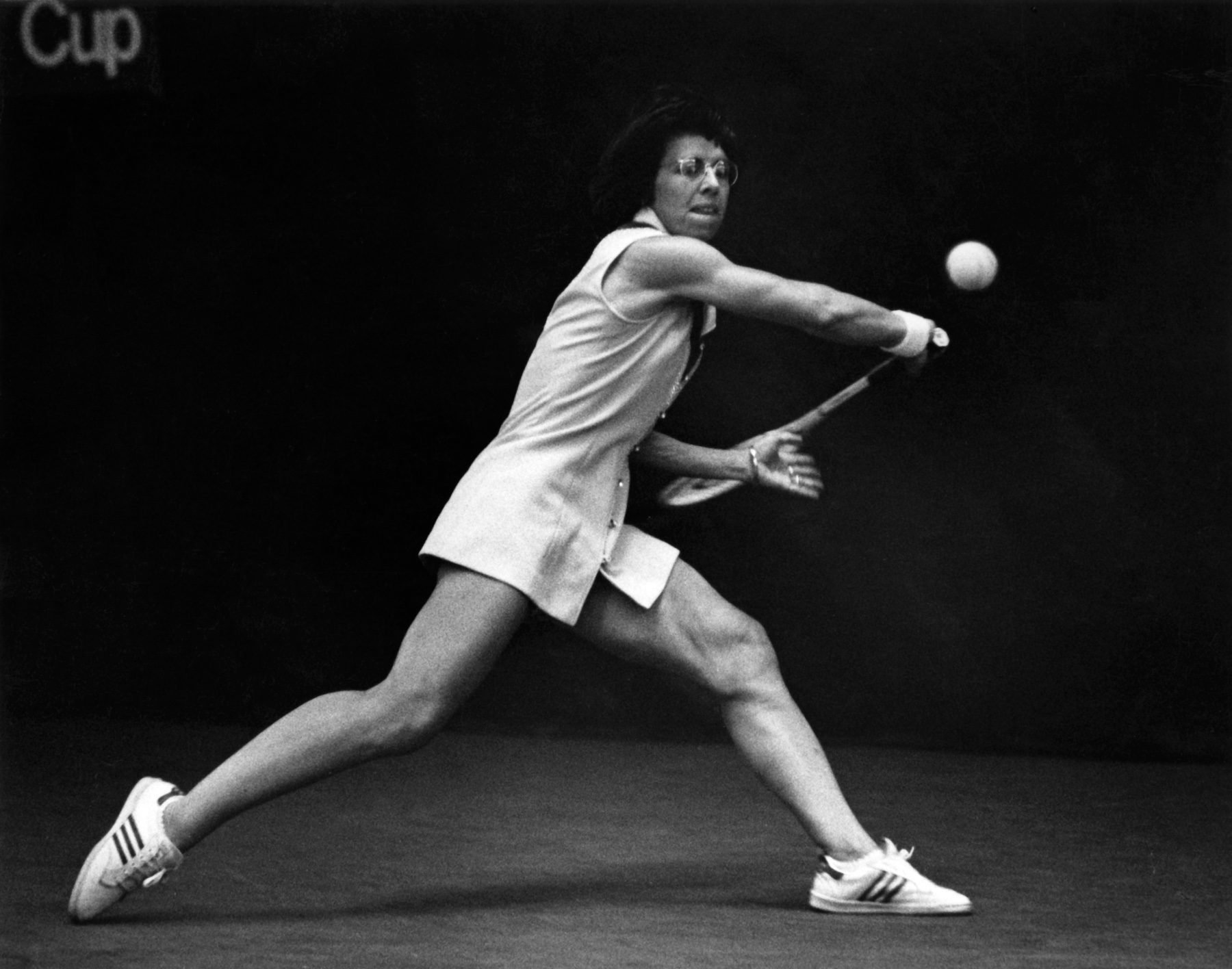 Black and white photo of Billie Jean King playing tennis.