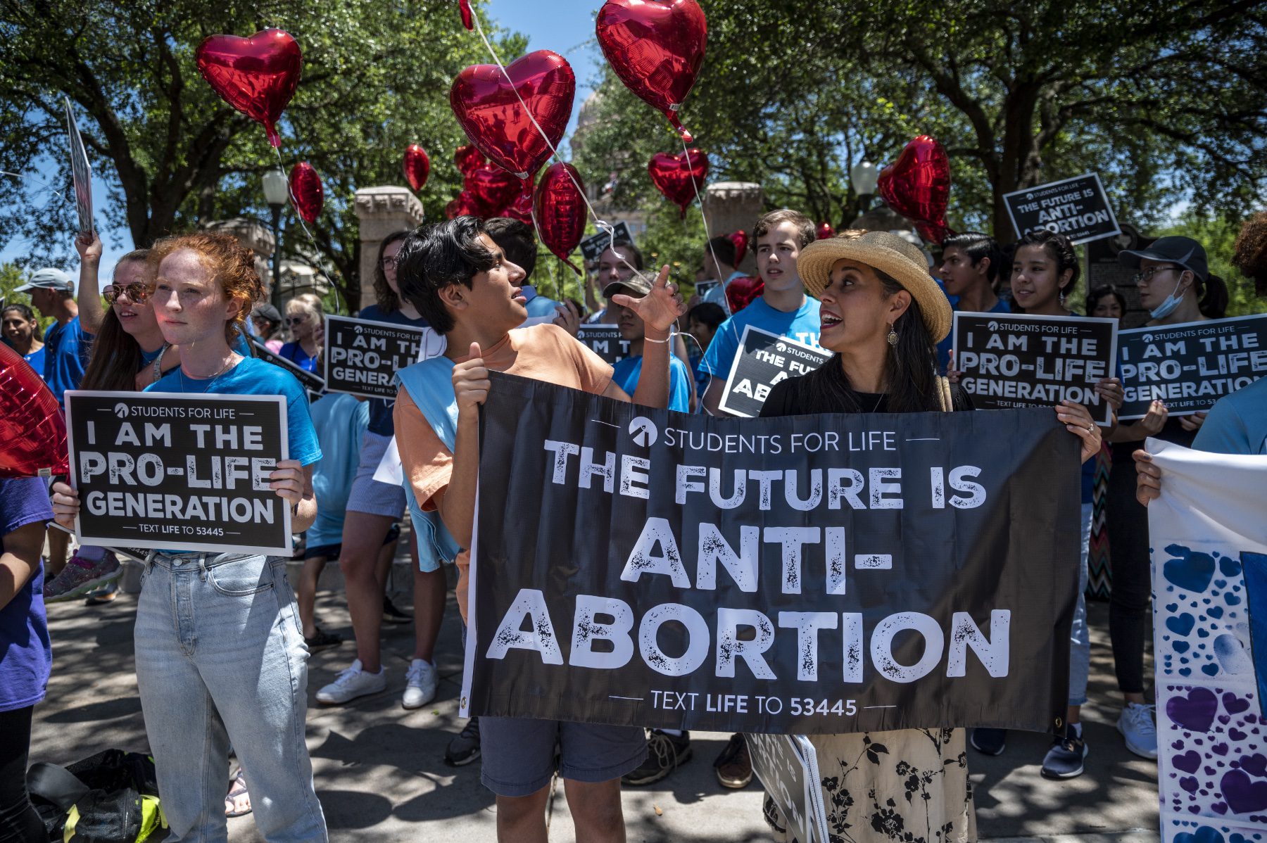 Anti-abortion protesters outside of the Texas Capitol with a sign that reads, "The future is anti-abortion."