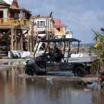 a search and rescue team in flooded Grand Isle, Louisiana