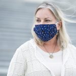 Susan Wild, wearing a blue face masks, stands on the steps on the U.S. Capitol.