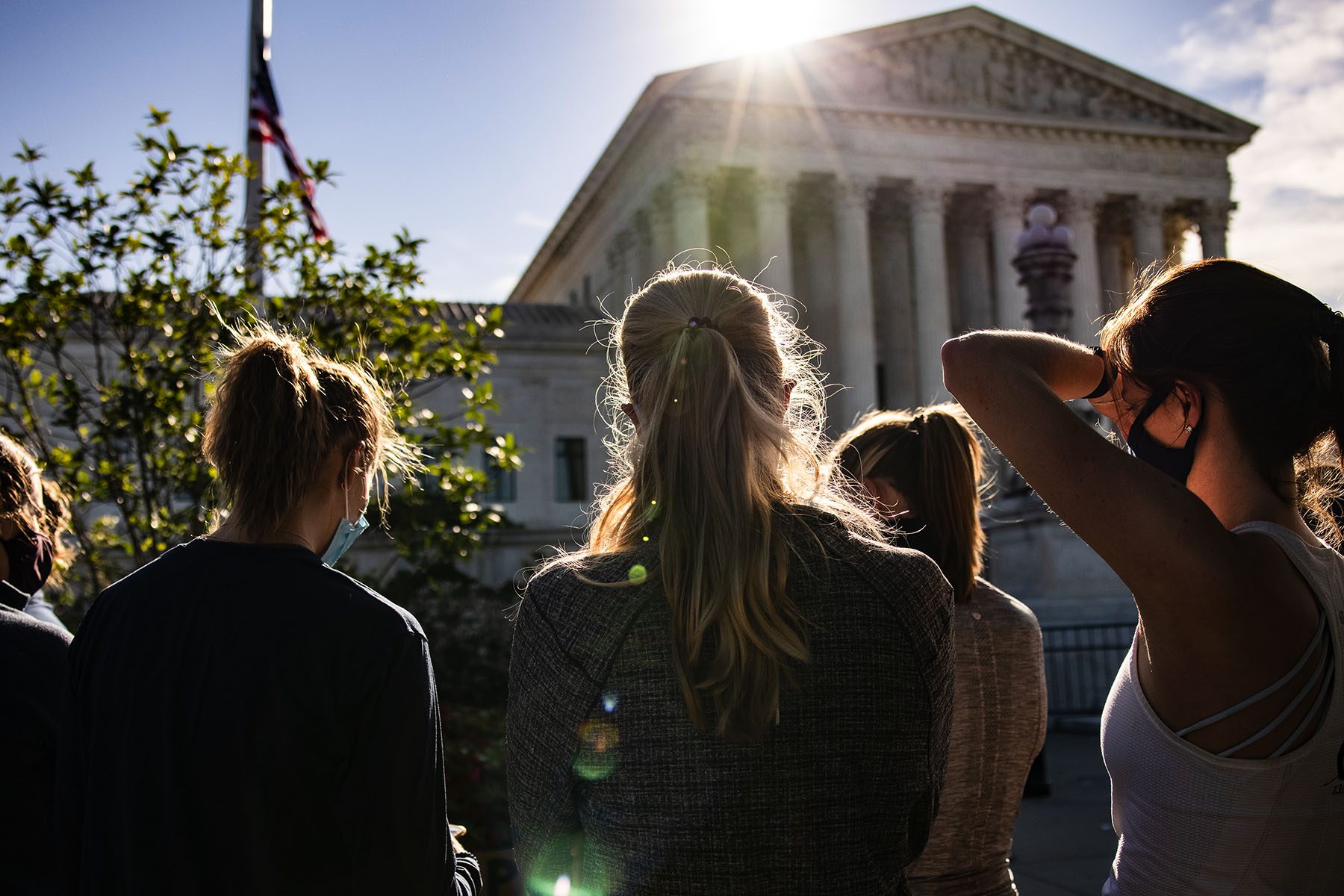Women are seen gathering in front of the U.S. Supreme Court.