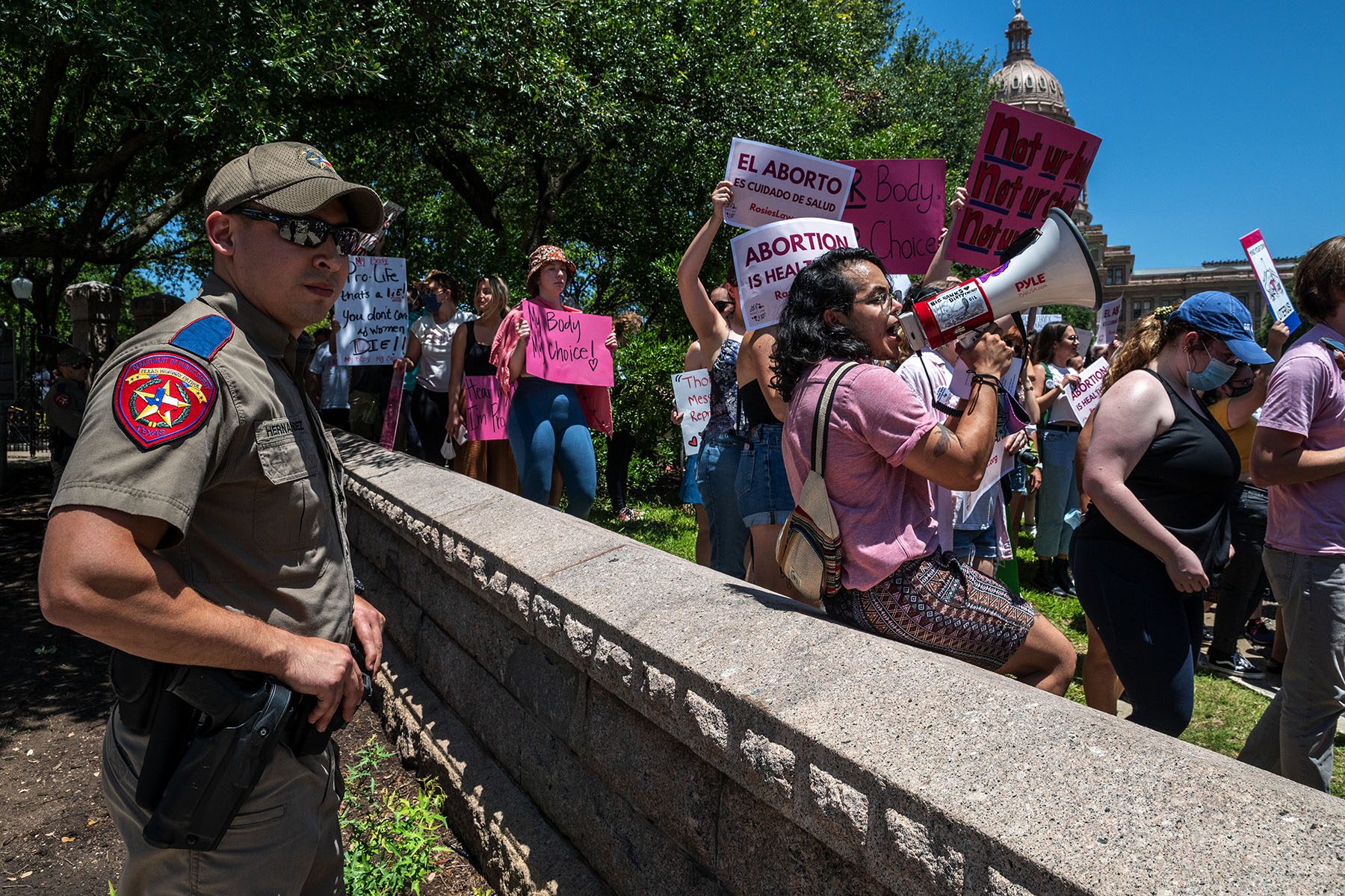 A capitol policeman surveils demonstrators.