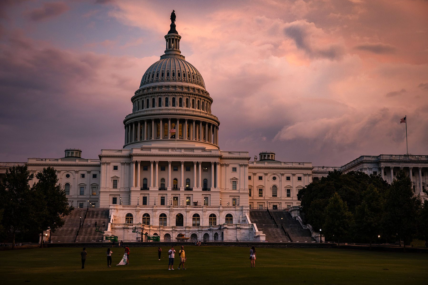 The U.S. Capitol Building is seen as the sun sets and large clouds from a thunderstorm run through the area.