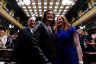 Gretchen Whitmer, Frank Liberati and Mallory McMorrow smile as people applaud.