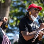 Andrea Jenkins speaks to community members at a park.