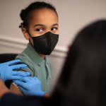 A child receives the Pfizer COVID-19 vaccine.