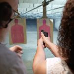 A woman takes part in a shooting lesson.