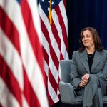 Kamala Harris listens during a conversation with Olympic athlete Allyson Felix.