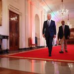 President Joe Biden and Human Rights Campaign youth ambassador Ashton Mota walk into the East Room for an event commemorating LGBTQ+ Pride Month at the White House on June 25, 2021.