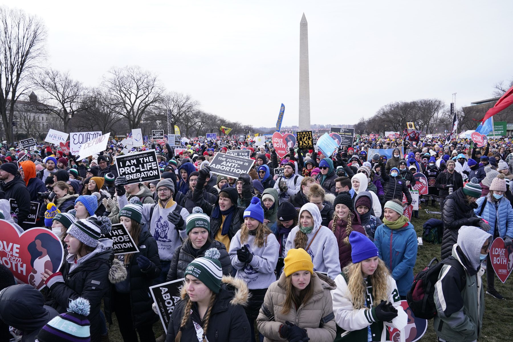 People attend the 2022 March for Life rally, with the Washington Monument in the background.
