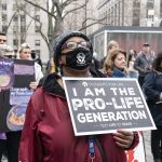 Woman with placard at anti-abortion protest in Foley Square, New York City