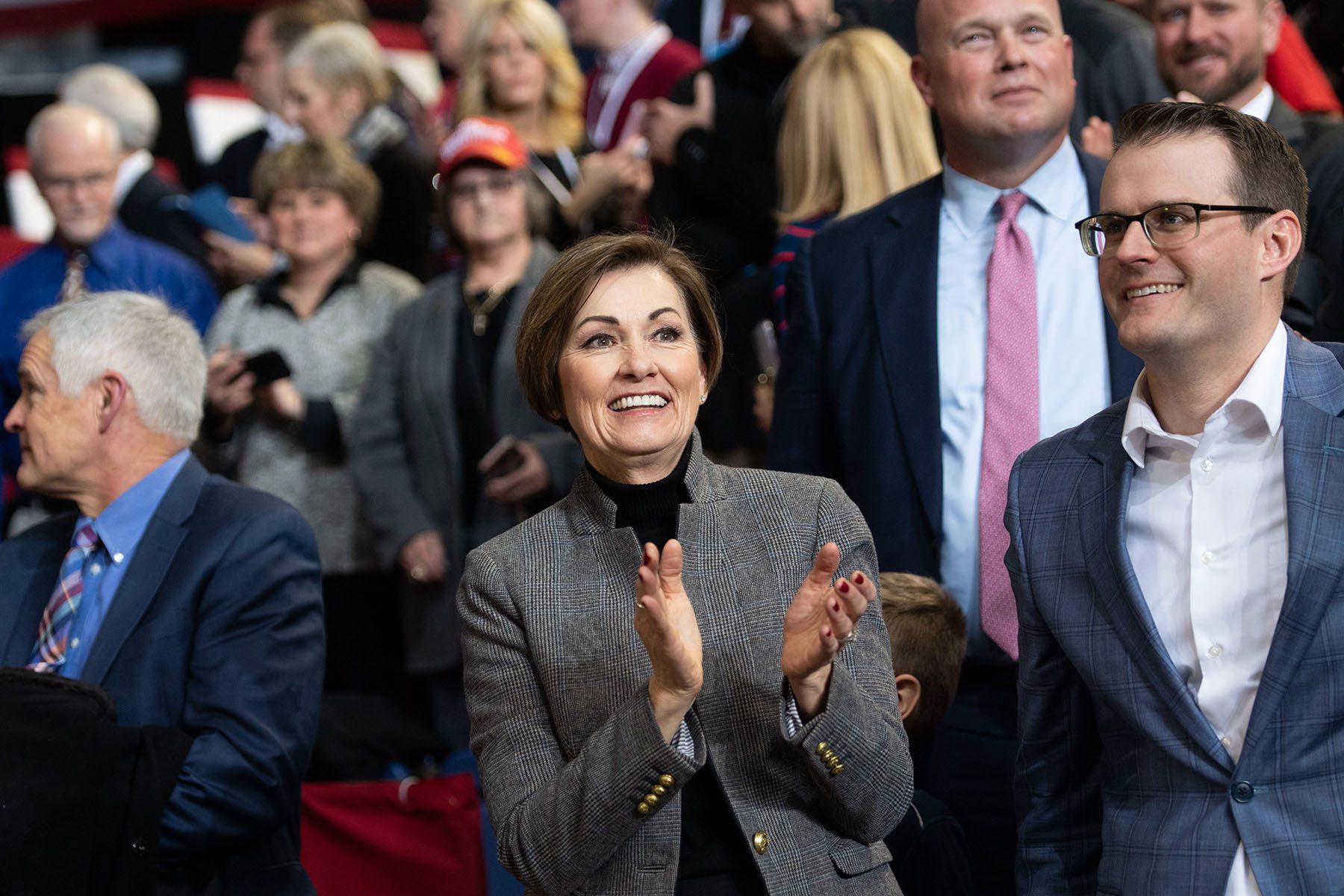 Kim Reynolds cheers and claps from the crowd at a "Keep America Great" rally.