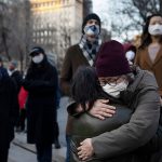 New Yorkers hug while rallying in Union Square.