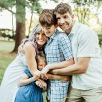 The Briggles pose for a family portrait in a park.