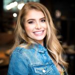 Demi Burnett smiles as she poses for a portrait.