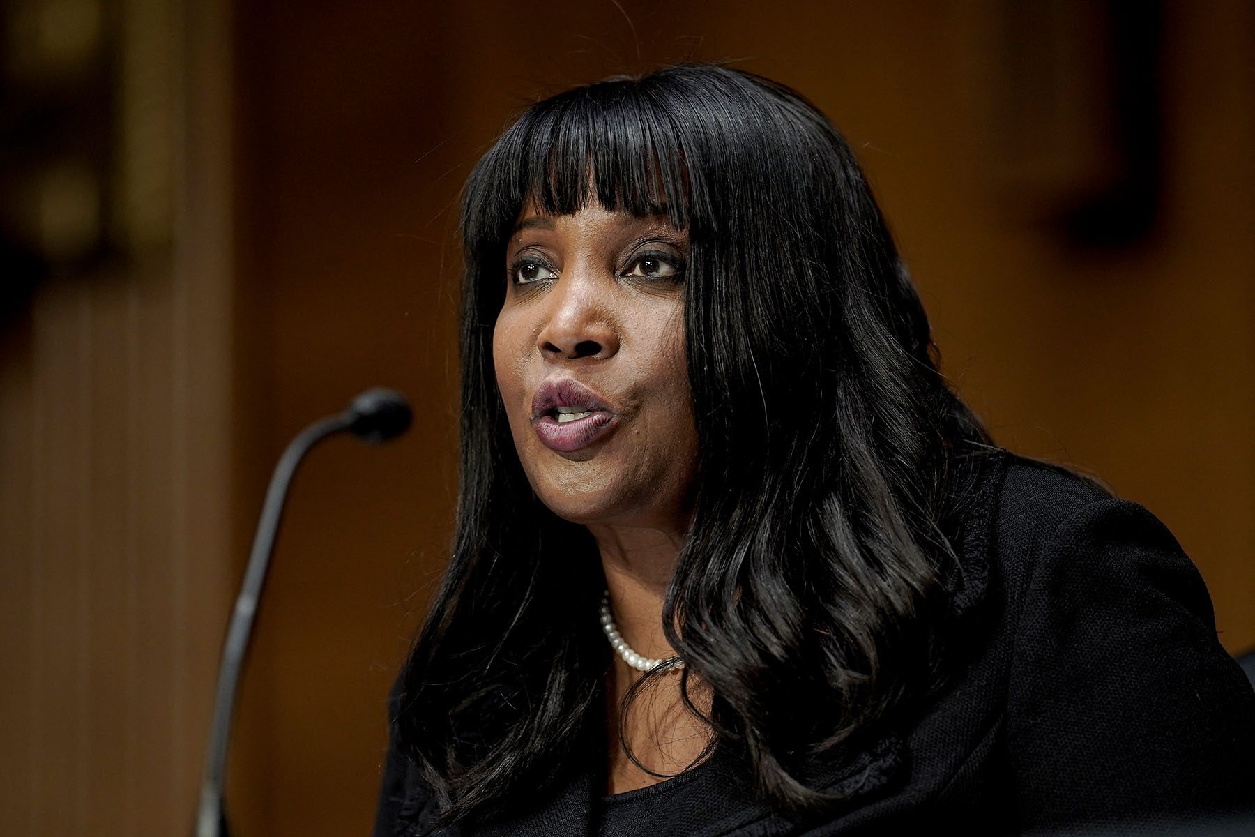 Lisa DeNell Cook speaks into a microphone during her confirmation hearing.
