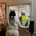 A woman stands at the check-in window of an abortion clinic in Louisiana.