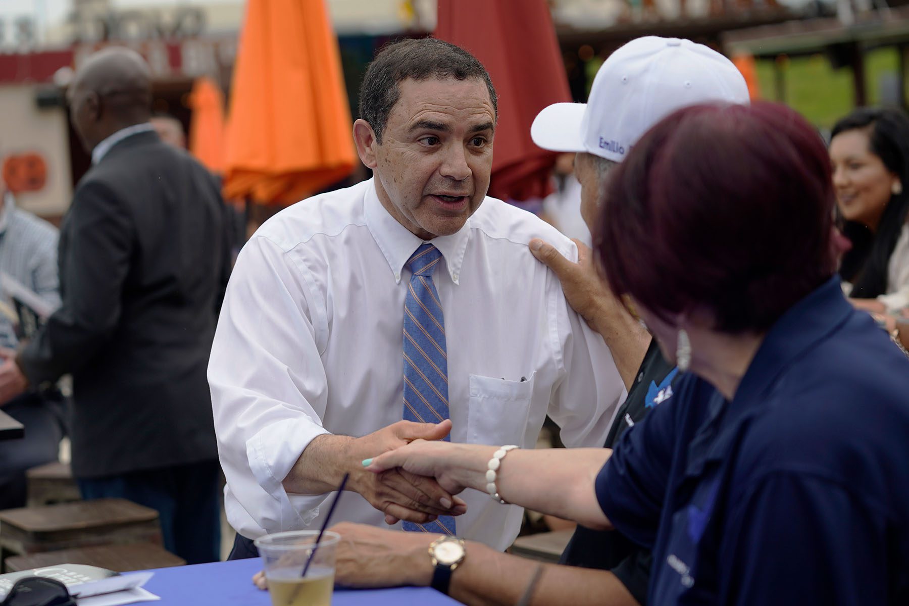 Henry Cuellar shakes a supporters hand at a campaign event.