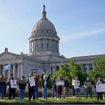 Abortion-rights supporters rally in front of the State Capitol. Signs read 